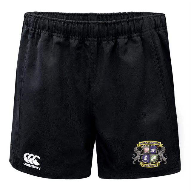 The Winchester Cannons Advantage Short 2.0 by EMB Canterbury features an elastic waistband, white Canterbury logo on the left leg, and a colorful Cannons crest on the right—ideal sustainable sportswear for athletes.