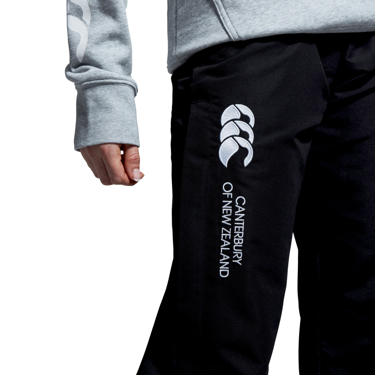 Wearing Women's Canterbury Open Hem Stadium Pant featuring the iconic logo on the leg, paired with a gray long-sleeve top—ideal for rugby training.