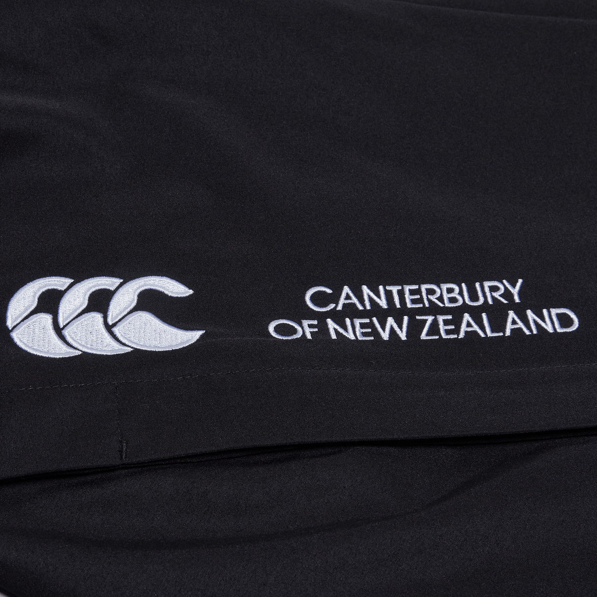 a black Canterbury Open Hem Stadium Pant with a white logo on it.