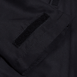 A close up of the pocket of a Canterbury black jacket.