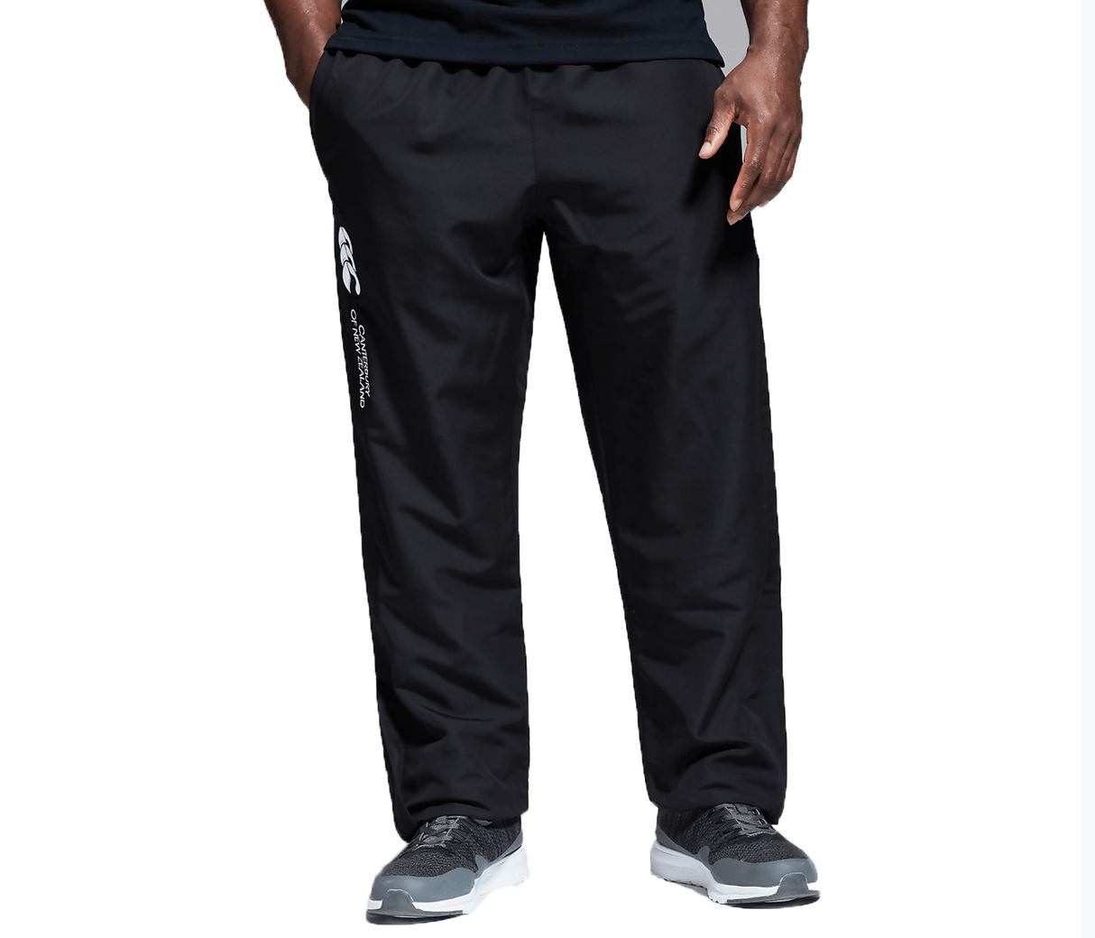 A man in Canterbury Open Hem Stadium Pant and a black shirt.