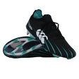 A pair of Canterbury Speed Falcon 2.0 Elite FG rugby boots in Jet Black and Baltic Green, featuring a white Canterbury logo—one boot stands upright while the other lies sole up to display the stud configuration; these lightweight cleats are engineered by Canterbury for maximum agility and speed on the field.