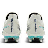 A pair of Canterbury Speed Falcon 2.0 Elite SG rugby boots in WHITE/BALTIC GREEN are shown from the back, featuring metal studs for soft ground, blue Canterbury branding, and “SPEED” text on the heels.