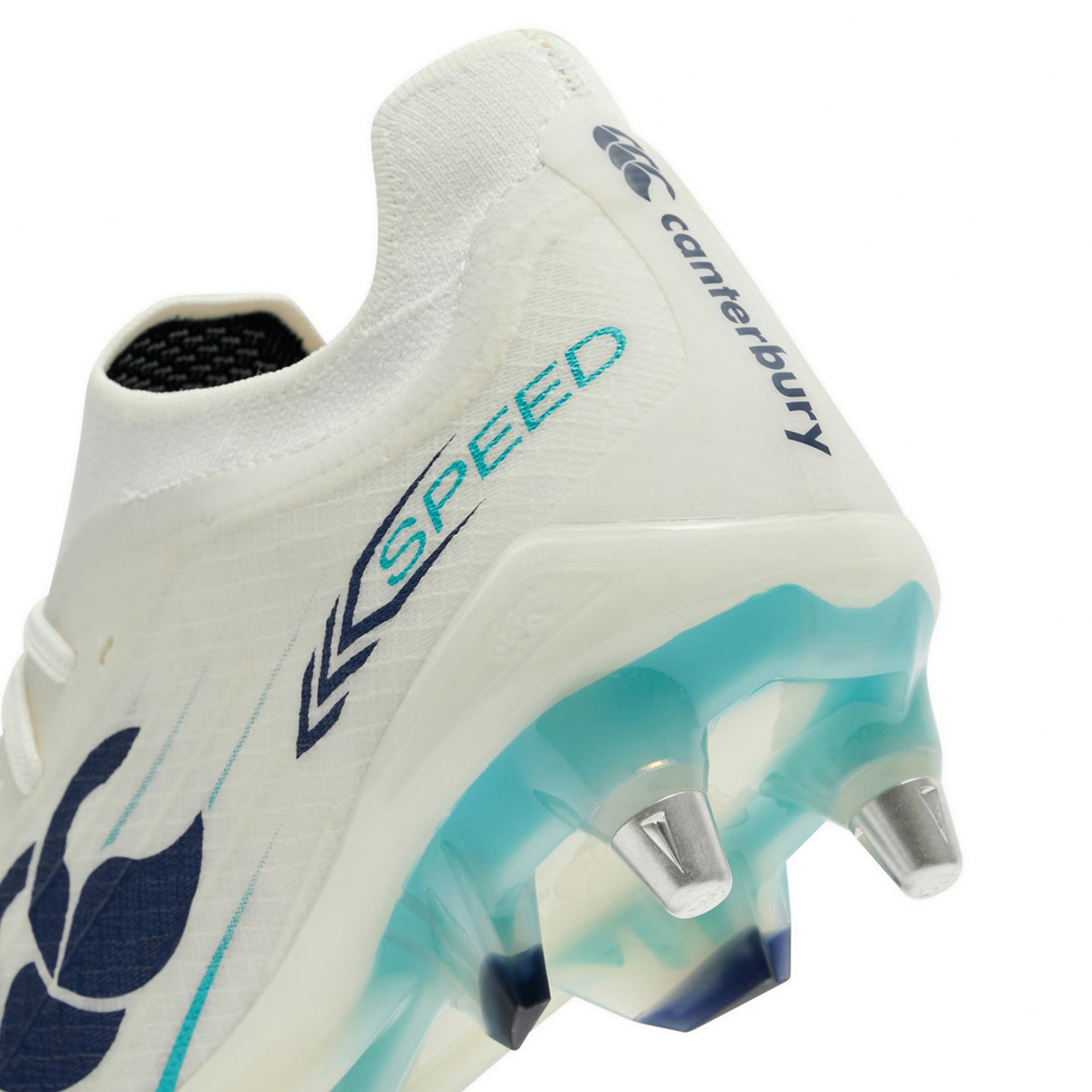 Close-up of a Canterbury Speed Falcon 2.0 Elite SG rugby boot in white and Baltic Green, featuring the word “SPEED” and teal-blue accents, designed for soft ground with metal studs on the sole.