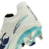 Close-up of a Canterbury Speed Falcon 2.0 Elite SG rugby boot in white and Baltic Green, featuring the word “SPEED” and teal-blue accents, designed for soft ground with metal studs on the sole.
