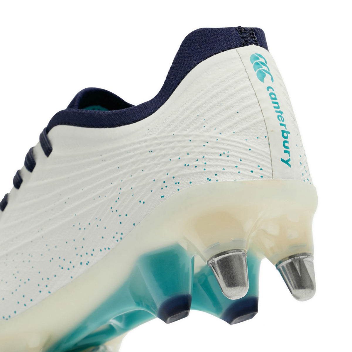 Close-up of white and Baltic Green Canterbury Stampede Groundbreak Elite SG rugby boots with metal studs on the heel.