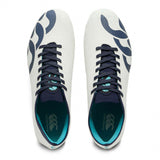Top-down view of white Canterbury Stampede Groundbreak Elite SG Rugby Boots with Baltic Green detailing, featuring dark blue laces, trim, side accents, and bright blue accents on the tongue and inner sole.