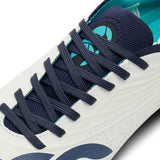 Close-up of a white and Baltic Green Canterbury Stampede Groundbreak Elite SG rugby boot with navy laces and a teal interior.