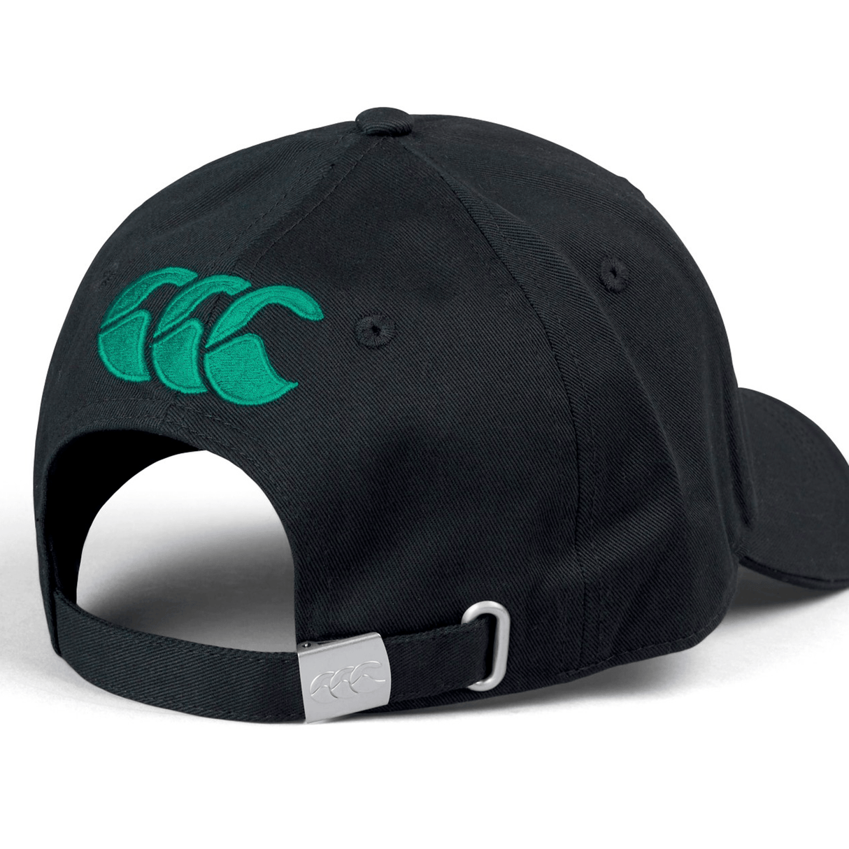 The Ireland 24 Drill Cap by Canterbury is a black adjustable cotton cap, featuring a green Canterbury logo on the back. It includes an adjustable strap with a metal buckle for a customized fit.