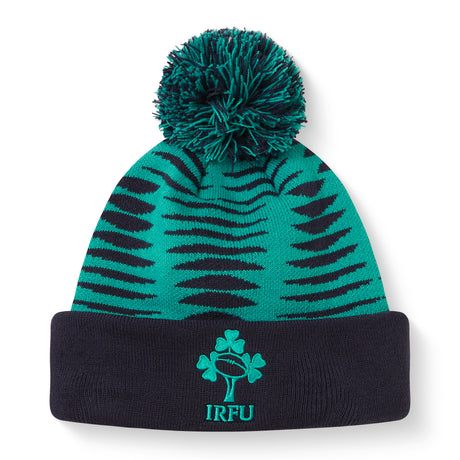 The Ireland 26 Bobble Hat by Canterbury is a green and black knitted acrylic beanie with a black cuff, topped with a pom-pom. It features the IRFU logo—complete with shamrock and rugby ball—embroidered on the front, making it an essential addition to any Ireland Rugby hat collection.
