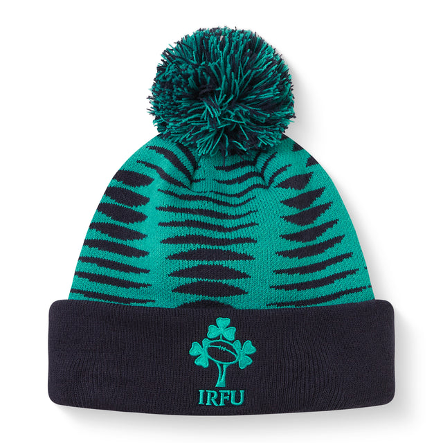 The Ireland 26 Bobble Hat by Canterbury is a green and black knitted acrylic beanie with a black cuff, topped with a pom-pom. It features the IRFU logo—complete with shamrock and rugby ball—embroidered on the front, making it an essential addition to any Ireland Rugby hat collection.
