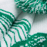 Close-up of the Ireland 26 Bobble Hat by Canterbury in white and green, featuring a pom-pom on top, a striped pattern, and textured stitches.