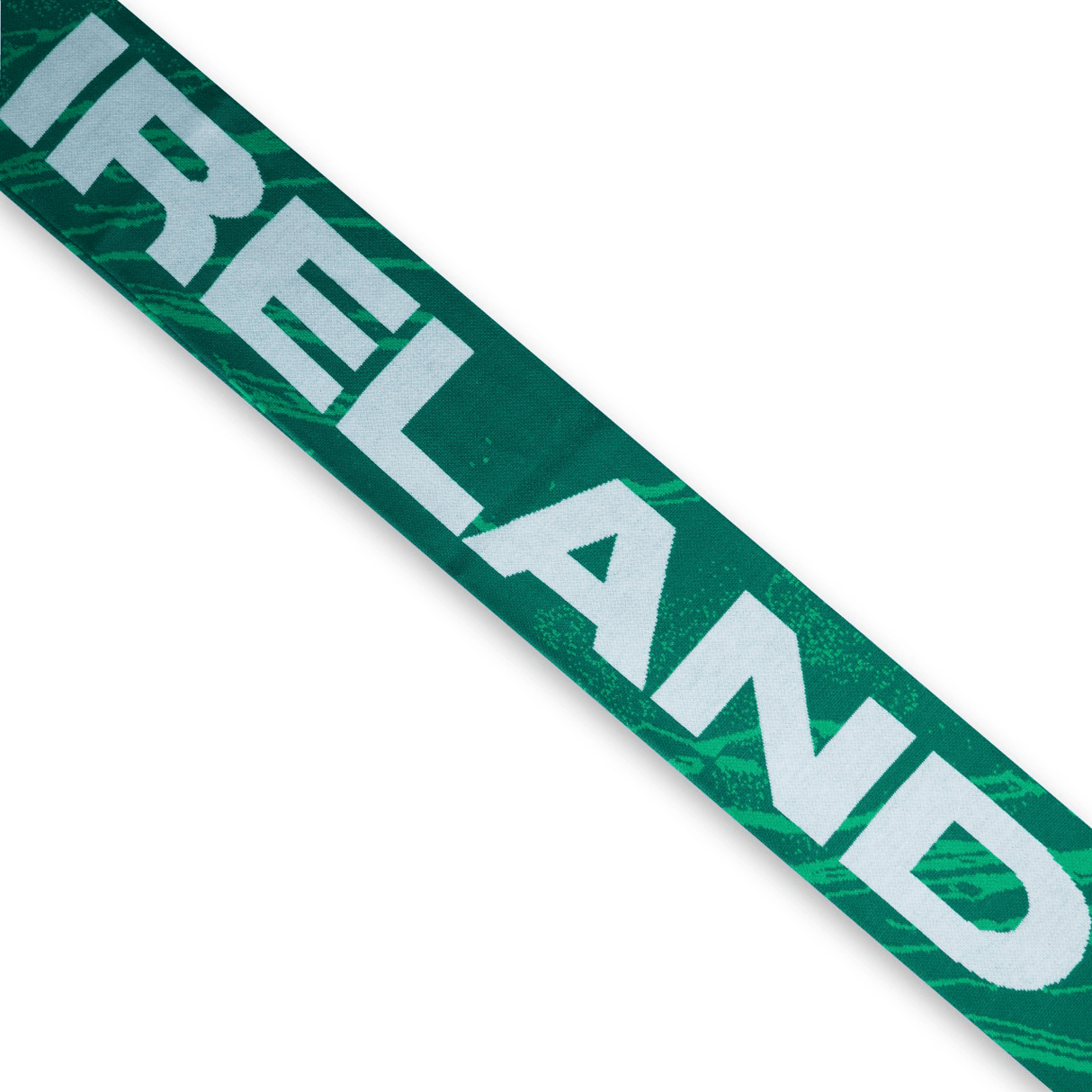 A green banner with the word "IRELAND" printed in large white letters, reminiscent of the cozy Ireland 24 Scarf by Canterbury.
