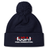 The USA Para Powerlifting Pom Pom Beanie by EMB Canterbury is a navy blue knit beanie with a pom-pom, featuring "USA PARA POWERLIFTING" and a barbell on the front cuff, inspired by classic Rugby style.