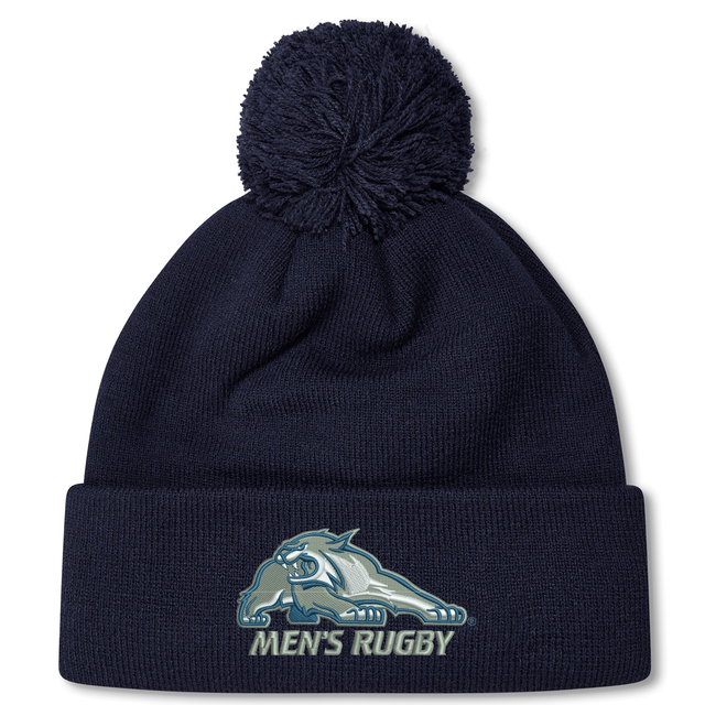 Navy blue University of New Hampshire Pom Pom Beanie by Canterbury, featuring a wildcat mascot logo and “MEN’S RUGBY” text on the cuff.