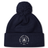 Introducing the New Saint Andrews College Pom Pom Beanie by Canterbury: a navy blue knit beanie with a playful pom-pom on top, featuring the white New Saint Andrews RFC logo embroidered on the cuff. Brought to you by EMB Canterbury.