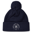 Introducing the New Saint Andrews College Pom Pom Beanie by Canterbury: a navy blue knit beanie with a playful pom-pom on top, featuring the white New Saint Andrews RFC logo embroidered on the cuff. Brought to you by EMB Canterbury.