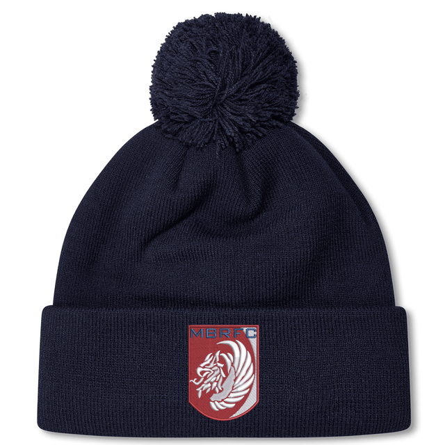 The Montgomery Bucks Griffins Pom Pom Beanie by EMB Canterbury is a navy blue beanie with a pom-pom and features a red crest patch with a white lion and "MBRFC" on the front.
