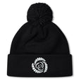 The Missoula All-Maggots Pom Pom Beanie by Canterbury is a black knit hat with a white spiral-patterned design on the front fold and a playful pom-pom on top. This fleece-lined beanie from EMB Canterbury combines warmth and style, making it the perfect choice for chilly days.