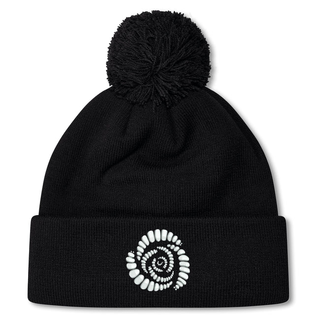 The Missoula All-Maggots Pom Pom Beanie by Canterbury is a black knit hat with a white spiral-patterned design on the front fold and a playful pom-pom on top. This fleece-lined beanie from EMB Canterbury combines warmth and style, making it the perfect choice for chilly days.