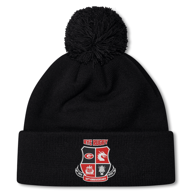 EMB Canterbury's Rye High School 10 Year Pom Pom Beanie by Canterbury is a black fleece-lined hat with a pom-pom, adorned with the "Rye Rugby" logo and the text "50th Anniversary" on the front.
