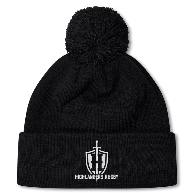 Introducing the Highlanders Rugby NC Pom Pom Beanie by Canterbury from EMB Canterbury: a black fleece-lined beanie featuring a pom-pom on top, the iconic Highlanders Rugby logo, and "Highlanders Rugby" embroidered on the front.