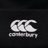 Detail of black knit beanie with white CCC logo on cuff.