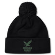The Zionsville Rugby Club Pom Pom Beanie by EMB Canterbury is a black knit hat with a green eagle and "Zionsville Rugby Est. 2003" on the front cuff, soft fleece lining, and classic pom-pom for added warmth.