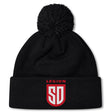 Stay warm in the San Diego Legion Rugby Academy Pom Pom Beanie by EMB Canterbury, featuring a black knit design, fleece lining, and "LEGION SD" in red and white on the front cuff.