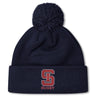 Stay warm in style with the St. Ignatius Rugby Pom Pom Beanie by EMB Canterbury, featuring a navy design, red and white "S" logo, "RUGBY" embroidery on the cuff, soft fleece lining, and playful pom-pom top.