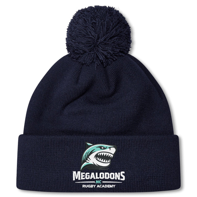 Stay warm with the EMB Canterbury NC Rugby Academy - Megalodons Pom Pom Beanie, a navy fleece-lined hat featuring a pom-pom, embroidered shark logo, and "Megalodons NC Rugby Academy" text on the front.