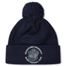 The Georgetown University RFC Pom Pom Beanie by Canterbury features a navy blue knit, fleece lining, pom-pom, bulldog graphic, and club logo—a perfect rugby fan hat from EMB Canterbury.