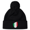 The newly arrived black Italy Shield Pom Pom Beanie by EMB Canterbury features an Italy Shield with vertical green, white, and red stripes.