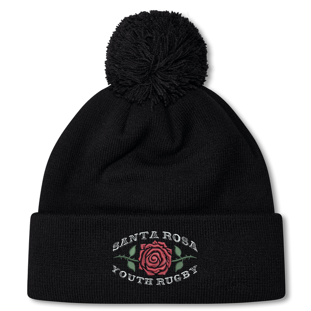 The Santa Rosa Youth Rugby Pom Pom Beanie by EMB Canterbury is a black knit rugby beanie with a pom-pom on top, featuring a rose graphic and “Santa Rosa Youth Rugby” embroidered on the front.