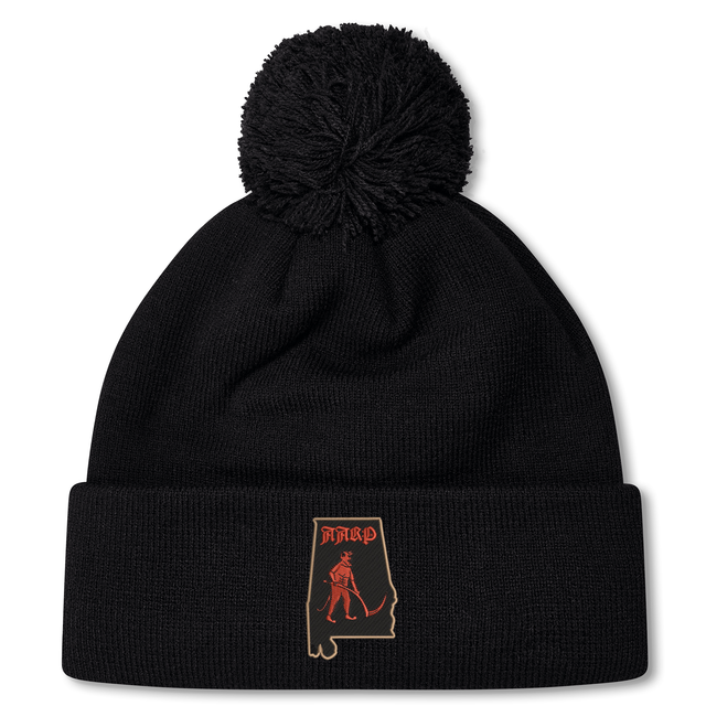 Aging Alabama Rugby Players Pom Pom Beanie by Canterbury featuring a patch of the state of Alabama with a red graphic of a grim reaper and the text “HARD.”.