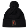 Aging Alabama Rugby Players Pom Pom Beanie by Canterbury featuring a patch of the state of Alabama with a red graphic of a grim reaper and the text “HARD.”.