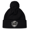 Black ICRON Pom Pom Beanie by Canterbury, featuring a pom pom and a patch with a rugby ball above the word “ICRON.”