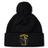 The Spartan Youth Rugby Pom Pom Beanie by EMB Canterbury features a black design with a pom-pom, fleece lining, and a Spartan helmet logo on the cuff—perfect for keeping rugby fans warm and stylish.