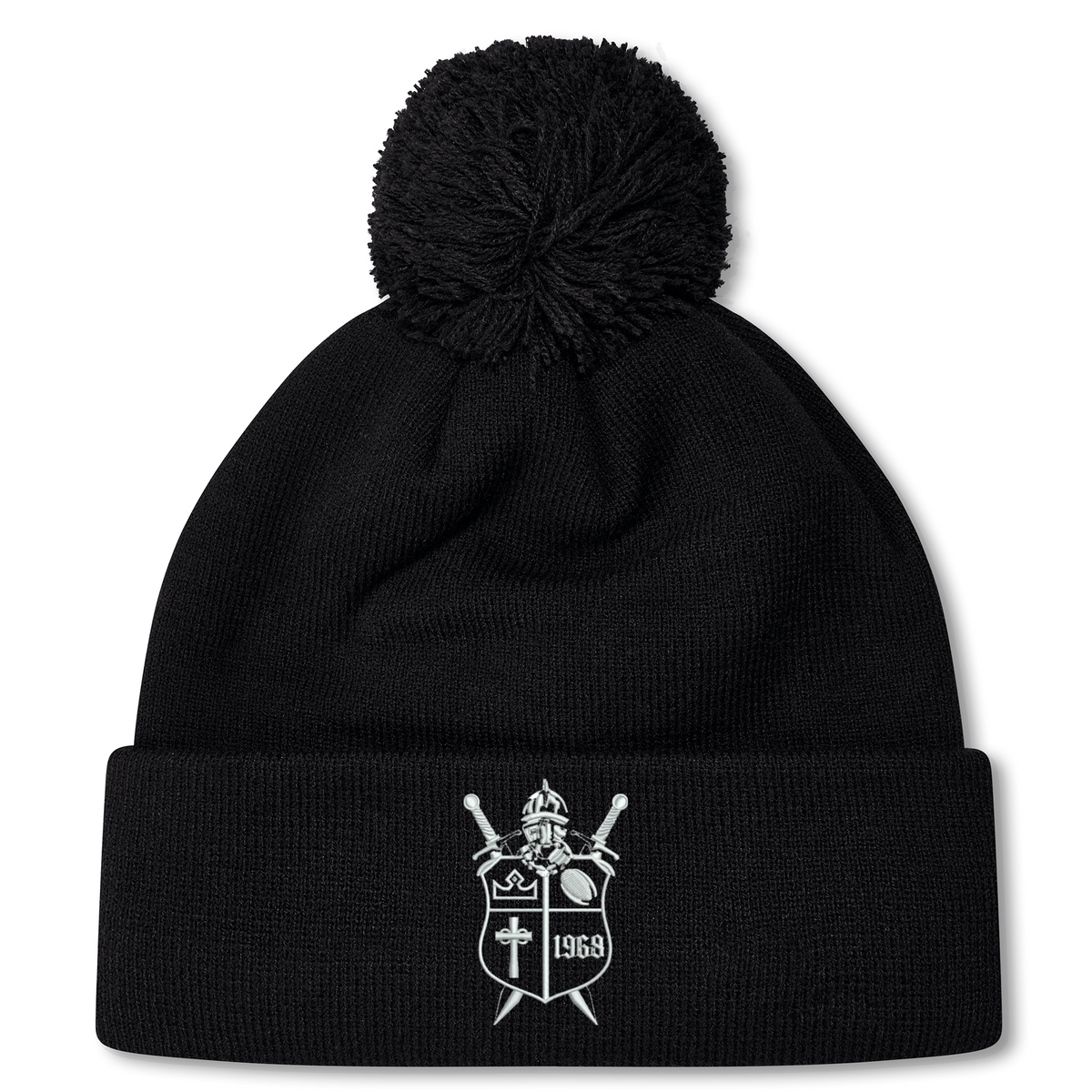 Black fleece-lined Cal Lutheran University Pom Pom Beanie by Canterbury, featuring an embroidered shield emblem with a helmet, swords, a cross, and the year 1969.