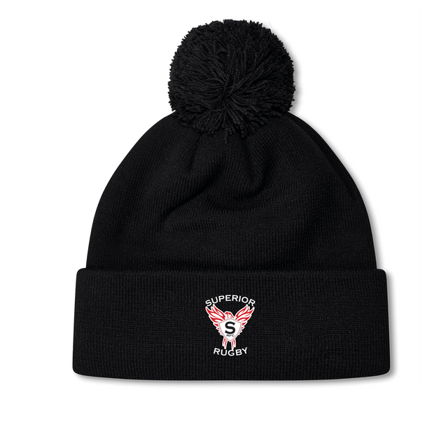 The Superior Rugby Club Pom Pom Beanie by EMB Canterbury is a black knit hat with a top pom-pom and an embroidered "Superior Rugby" wings logo on the folded cuff.