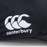 Close-up of the Canterbury logo, featuring three white overlapping curves above the word "canterbury," embroidered on a dark fabric background of the Ireland 24 Tech Logo Cap by Canterbury with an adjustable strap.
