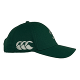 The Ireland 24 Tech Logo Cap by Canterbury is a green cap with silver logo embroidery on the side and front, featuring a curved brim, adjustable strap, and a button on top.