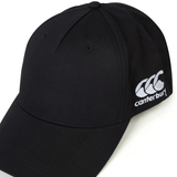 A black World Rugby Shop Flexfit Drill Cap by Canterbury with a curved brim and an embroidered white EMB Canterbury logo on the side.