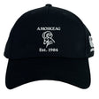 The Amoskeag Rugby Club Flexfit Drill Cap by EMB Canterbury features a black design with a white ram's head logo and "AMOSKEAG Est. 1984" embroidered on the front, offering a stylish custom cap for everyday wear.