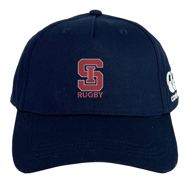 The St. Ignatius Rugby Flexfit Drill Cap by EMB Canterbury features a navy blue curved brim, red and white embroidered "S" and "RUGBY" text on the front, and a white Canterbury logo on the side.