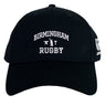 The Birmingham Rugby Text Logo Flexfit Drill Cap by Canterbury from EMB Canterbury showcases “Birmingham Rugby” along with small anvil, hammer, and rugby player icons embroidered in white on the front—a premium cap inspired by classic Canterbury style.