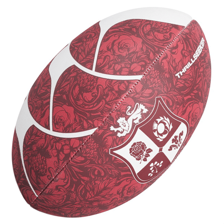 The British & Irish Lions 2025 Thrillseeker Supporters Ball by Canterbury showcases a striking red and white design, enhanced by decorative patterns and a shield with a lion, rose, and thistle crest. Crafted from durable synthetic rubber, this ball offers a standard rugby grip for an exceptional gameplay experience.
