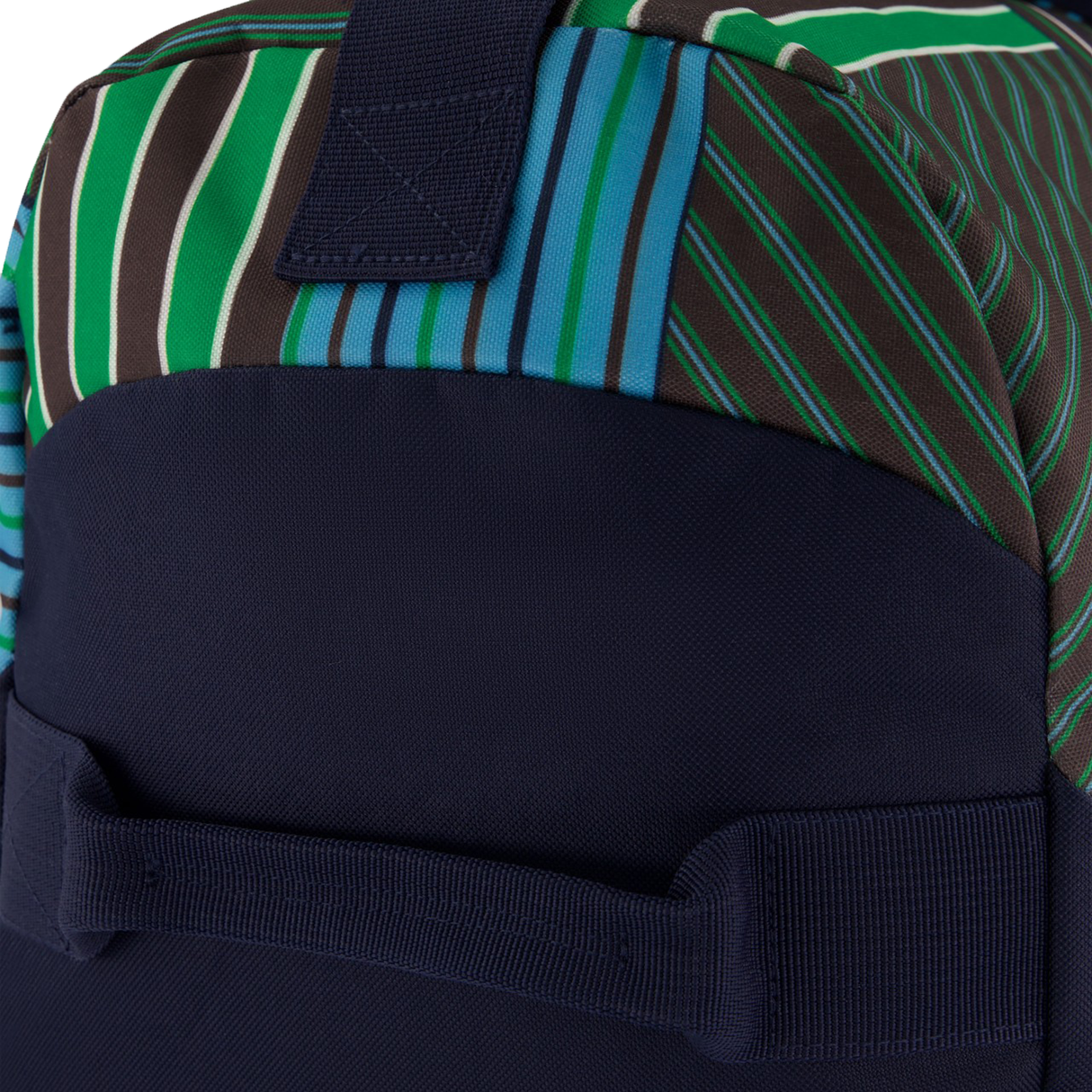 Close-up of a Canterbury Uglies Packaway Duffle Bag H125, featuring green, blue, and brown diagonal stripes with solid dark blue fabric—reinforced stitching and sturdy handle make it ideal as a stylish sports gear bag.