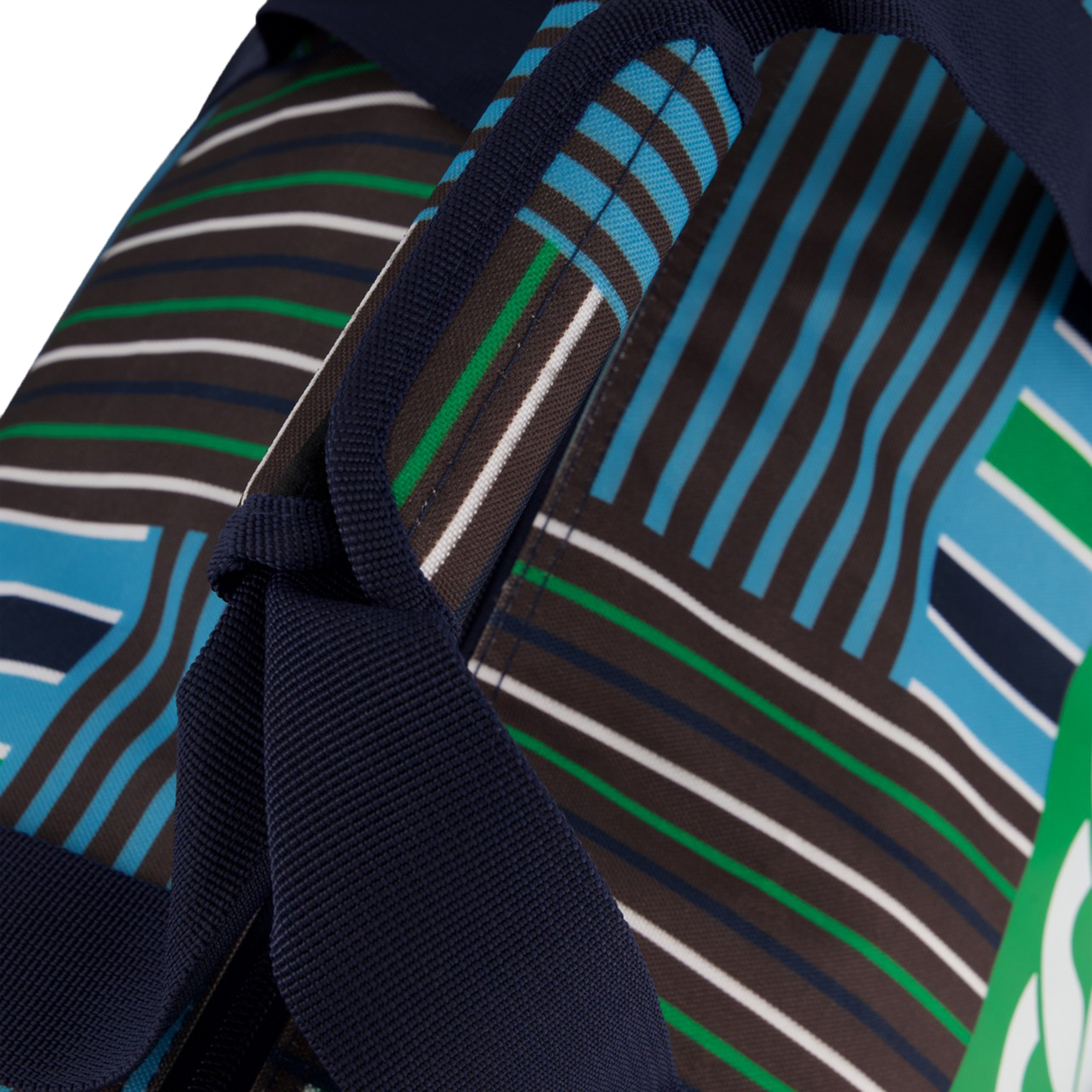 Close-up of the Uglies Packaway Duffle Bag by Canterbury H125, with a navy strap and geometric green, blue, brown, and white stripes and shapes.