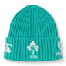 The Ireland 26 Beanie by Canterbury is a teal ribbed knit hat featuring embroidered white logos, including a shamrock rugby emblem and “IRFU” text on the folded brim.